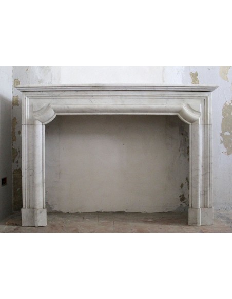 Antique "Boudin" fireplace in white Carrara marble. This fire surround has modern and elegant shapes.
