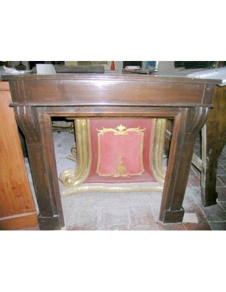 Elegant Antique wooden fireplace surround dating back to the 19th century.