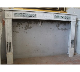 Big antique Neoclassical fireplace mantel carved in white Carrara marble with green marble inlays.