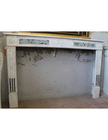 Big antique Neoclassical fireplace mantel carved in white Carrara marble with green marble inlays.