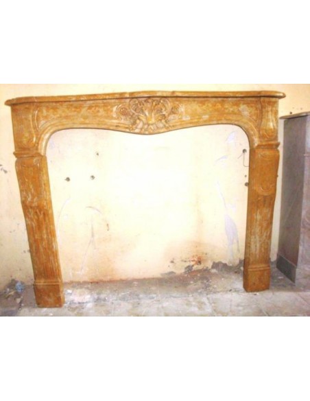 Art Nouveau style fireplace surround carved in yellow "Giallo Reale" marble.
