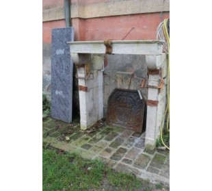 A fireplace mantel with sober and elegant lines, called “Champagnard,” carved out of light-colored stone.