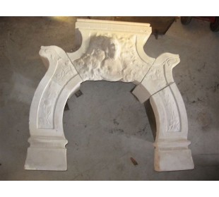 Antique stone fireplace with the sculpture of the face of a woman. This Art Nouveau mantel is signed.