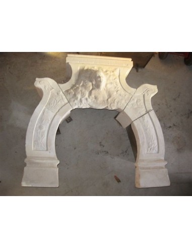 Antique stone fireplace with the sculpture of the face of a woman. This Art Nouveau mantel is signed.