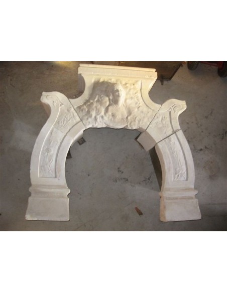 Antique stone fireplace with the sculpture of the face of a woman. This Art Nouveau mantel is signed.
