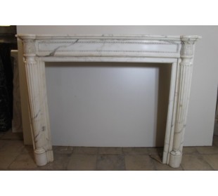 Truly antique Neoclassical fireplace carved in white Statuary marble with fluted columns and perlage.