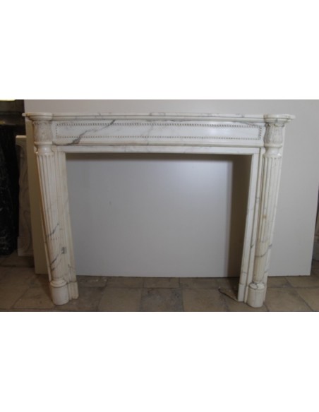 Truly antique Neoclassical fireplace carved in white Statuary marble with fluted columns and perlage.