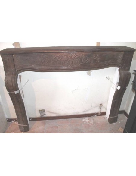 Antique fireplace mantel carved out of oak. This fireplace is an alternative to marble and stone fireplaces.