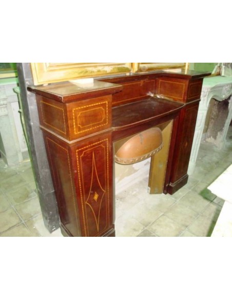 Antique Art Deco fireplace mantel coming from England. This antique English fire surround is carved in Mahogany wood.